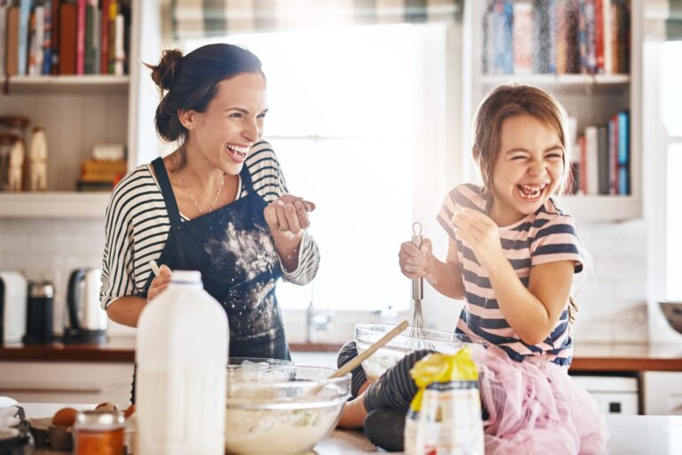 Moeder en dochter bakken samen en lachen in de keuken